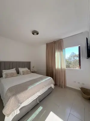 a bedroom with a large bed and a window at Cabo vip in Oulad Akkou