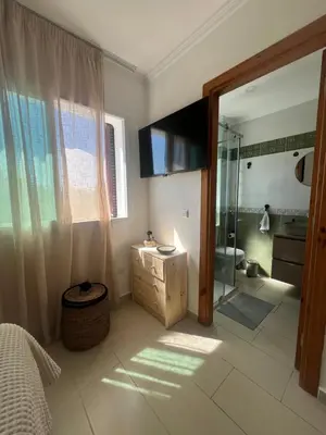 a bathroom with a shower and a sink and a mirror at Cabo vip in Oulad Akkou
