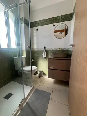 a bathroom with a toilet and a glass shower at Cabo vip in Oulad Akkou