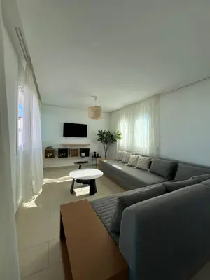 a living room with a couch and a table at Cabo vip in Oulad Akkou