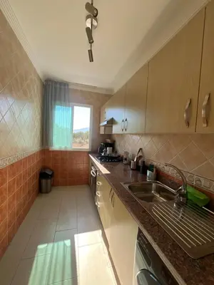 a kitchen with a sink and a counter top at Cabo vip in Oulad Akkou