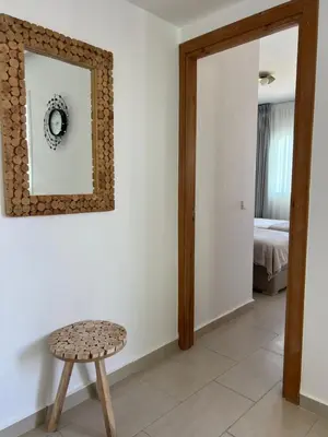 a room with a stool and a mirror and a bed at Cabo vip in Oulad Akkou