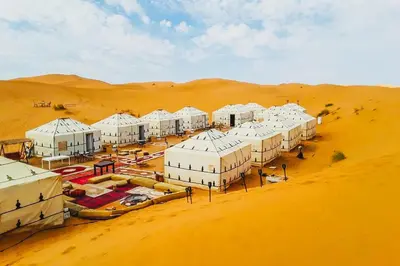 an aerial view of a desert with white buildings at Merzouga Luxurious Stay in Merzouga