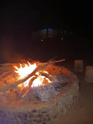a fire pit with snow on it at night at Camp sahara in Oulad Akkou