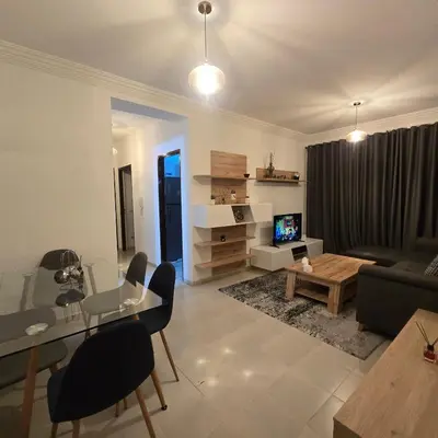 a living room with a couch and a table at Appartement Confortable à Chouiter in Chouiter