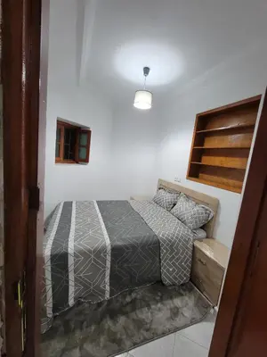 a bedroom with a bed in a white room at Studio bahaji in Oulad Akkou