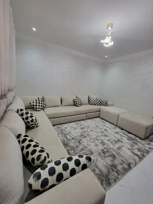 a living room with a couch and pillows at Studio bahaji in Oulad Akkou
