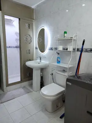 a bathroom with a toilet and a sink and a mirror at Studio bahaji in Oulad Akkou