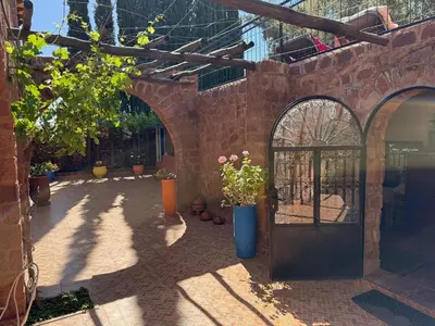 an entrance to a brick building with a door and plants at Beautiful peaceful haven with free breakfast in Aghmat
