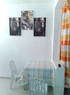 four pictures of a man hanging on a wall at Studio meublé calme in Oulad Akkou