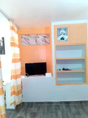 a room with a desk with a computer on it at Studio meublé calme in Oulad Akkou