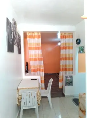 a living room with a table and a chair at Studio meublé calme in Oulad Akkou