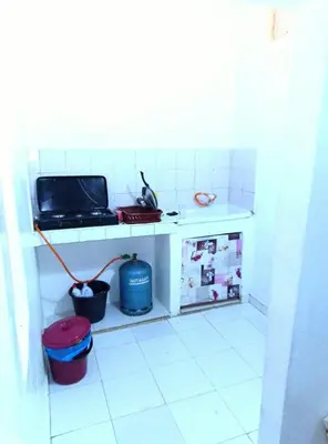 a kitchen with a counter and a stove and a sink at Studio meublé calme in Oulad Akkou
