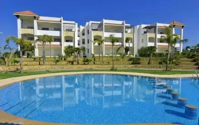 a large swimming pool in front of a building at إقامات أهلا قرب مرجان طريق الرباط in Oulad Akkou