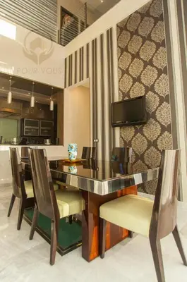 a dining room table with chairs and a television at إقامات أهلا قرب مرجان طريق الرباط in Oulad Akkou