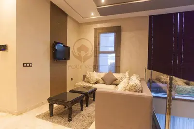a living room with a couch and a tv at إقامات أهلا قرب مرجان طريق الرباط in Oulad Akkou
