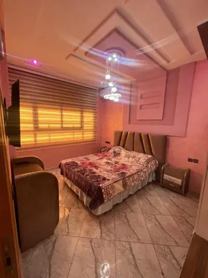 a bedroom with a bed and a window and a couch at Apparemment 3 chambre in Oulad Akkou