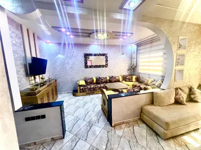 a living room with a couch and a tv at Apparemment 3 chambre in Oulad Akkou