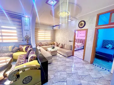 a large living room with a couch and a table at Apparemment 3 chambre in Oulad Akkou