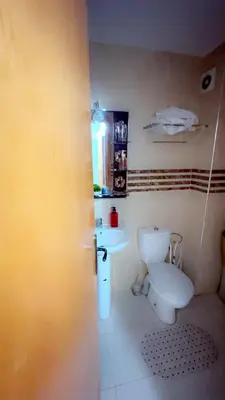 a bathroom with a toilet and a sink at البستان in Oulad Akkou