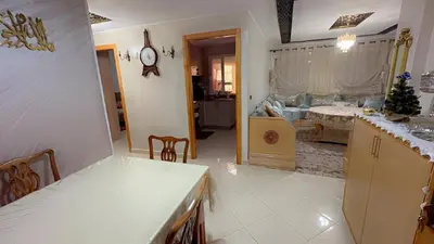 a kitchen with a table and a counter top at البستان in Oulad Akkou