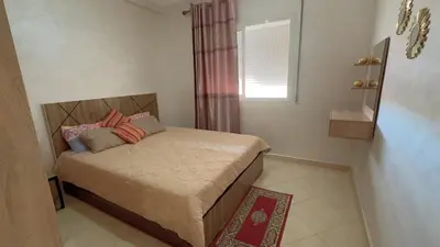 a small bedroom with a bed with a window at البستان in Oulad Akkou