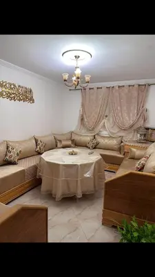 a living room with a couch and a table at البستان in Oulad Akkou