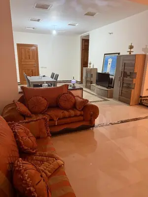 a living room with a couch and a table at Champ de course in Oulad Akkou