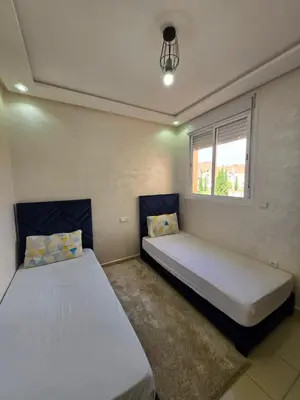 a bedroom with two beds and a window at Appartement de luxe in Ifrane