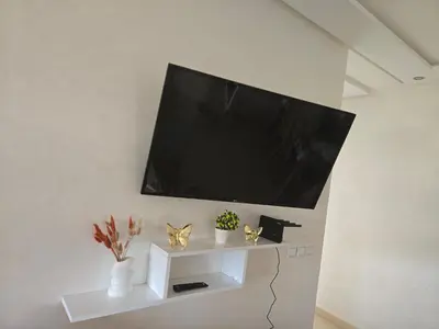 a flat screen tv hanging on a wall at Appartement de luxe in Ifrane