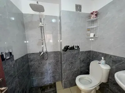 a bathroom with a shower and a toilet and a sink at Appartement de luxe in Ifrane