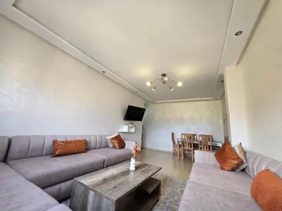 a living room with a couch and a table at Appartement de luxe in Ifrane