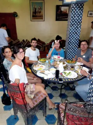 a group of people sitting around a table at Mom's food in Oulad Akkou