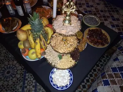 a table with a bunch of fruits and vegetables on it at Mom's food in Oulad Akkou