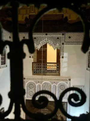 a view of a building through a metal fence at Dar Drouj a Special 14th Century Familyhouse Riad in Fès