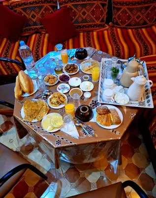 a table with breakfast foods and drinks on it at Riad IZRAREN in FIGUIG in Zenaga