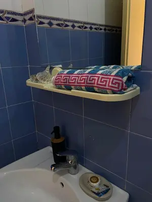 a blue bathroom with a sink and a mirror at Maison D'hôtes Ait Mouli in Bzou