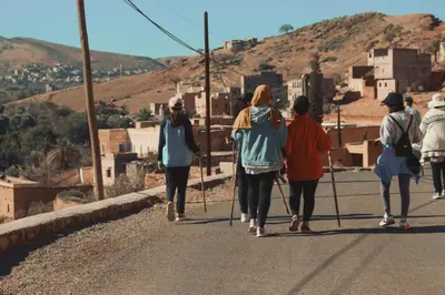 a group of people walking down a road at Maison D'hôtes Ait Mouli in Bzou