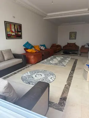 a living room with couches and rugs at Champ de course in Oulad Akkou