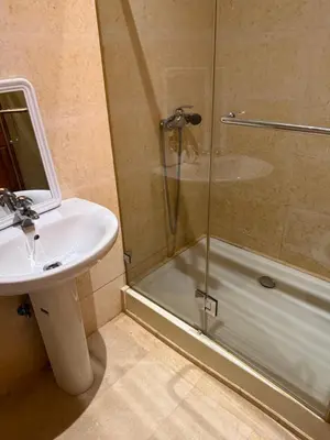 a bathroom with a shower and a sink and a shower at Champ de course in Oulad Akkou