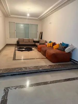 a living room with two couches and a couch at Champ de course in Oulad Akkou