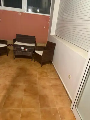 a room with chairs and a table and a window at Champ de course in Oulad Akkou