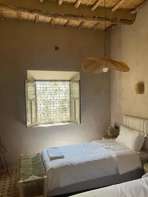 a bedroom with two beds and a window at Ranch Skouraya in Tajante