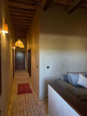 a living room with a couch and a hallway at Ranch Skouraya in Tajante