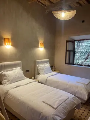 a bedroom with two beds and a window at Ranch Skouraya in Tajante