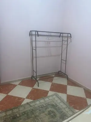 a shelf in a room with a tiled floor at Kawtar in Meknès