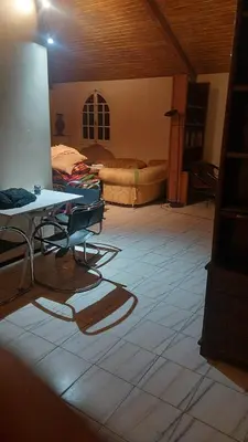 a room with a table and chairs on a tiled floor at Houria in Oulad Akkou