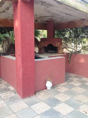a brick wall with a brick oven in a house at Houria in Oulad Akkou