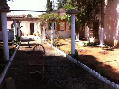 a chair sitting in the yard of a house at Houria in Oulad Akkou