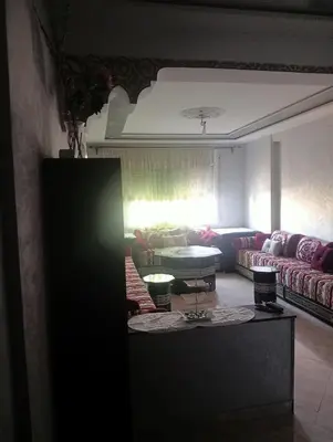 a living room with a couch and a table at Malak in Taza